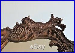 Face à main en bois sculpté décor de monstre marin miroir art populaire