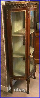 Vitrine en bois de placage garniture de laiton toutes faces vitrées. XX siècle